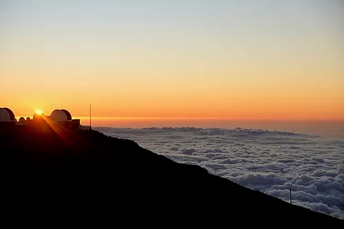 Sunset seen above the cloud layer from near the 10,023-foot Haleakalā summit.