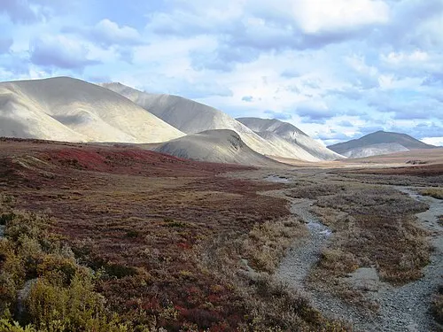 Red autumn tundra and rounded mountains in the upper Salmon River drainage of Kobuk Valley National Park in early September.